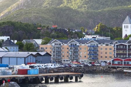 Aerial view of Svolvær Island city with majestic alps in the background.