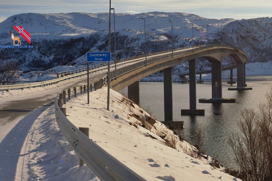 Scenic road leading to Sommarøy Island from Tromsø, surrounded by snow-capped mountains and coastal views.