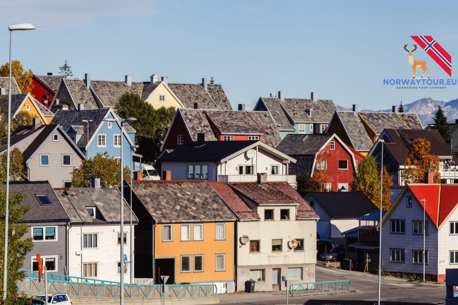 Aerial view of Tromsø city with its snowy mountains and harbor.